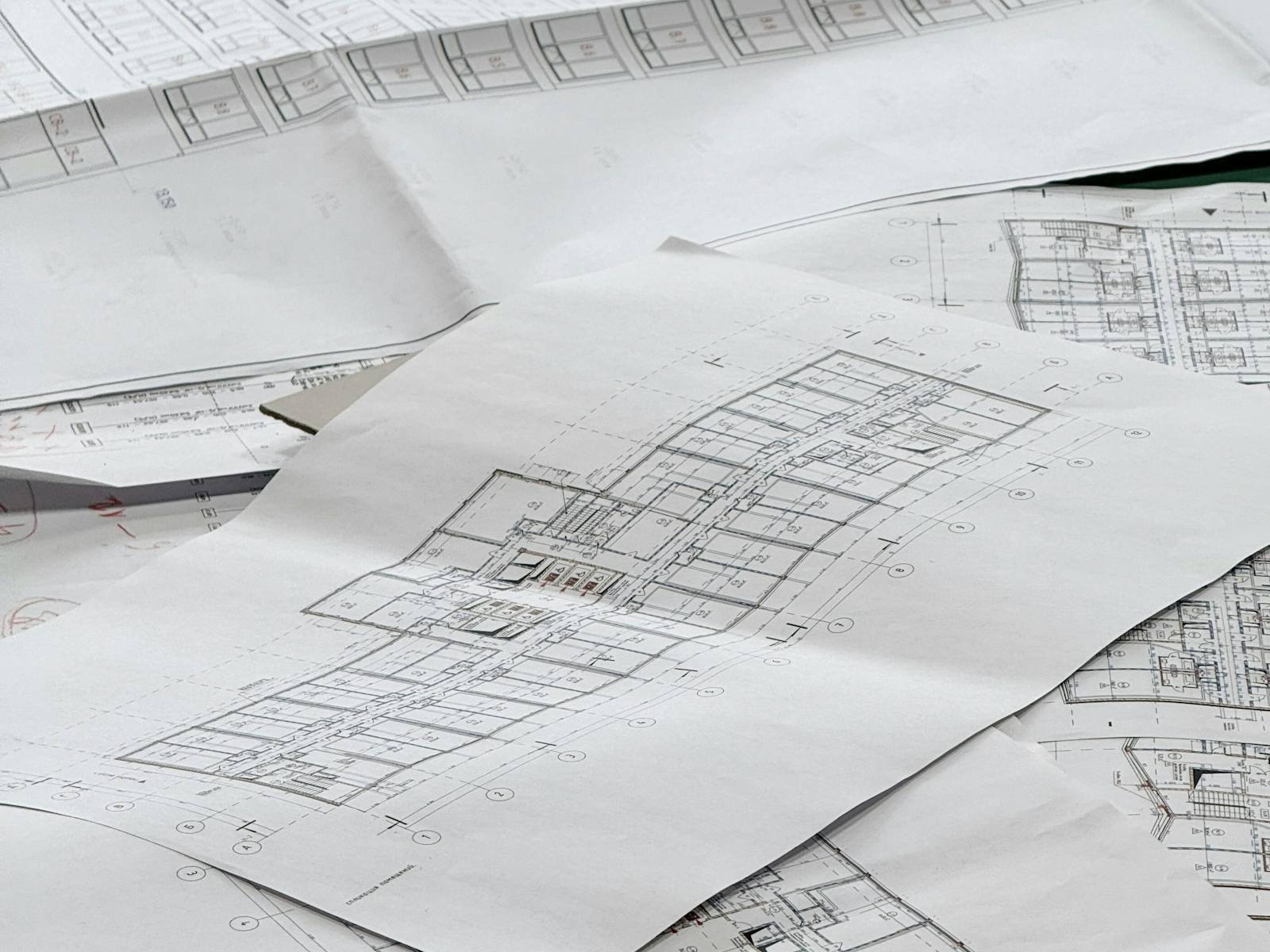 Blueprint and mechanical drawings on a desk for California plan check submission