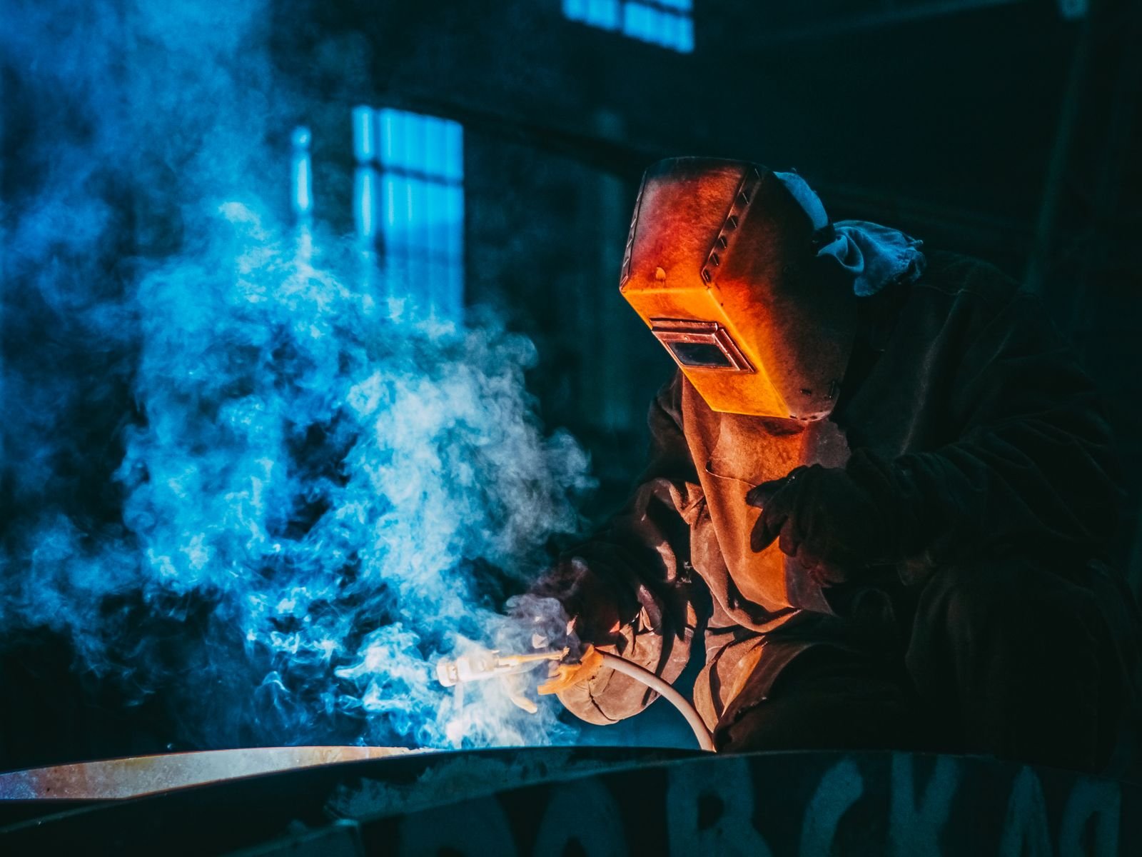 Welder at work in an in-house sheet metal fabrication shop